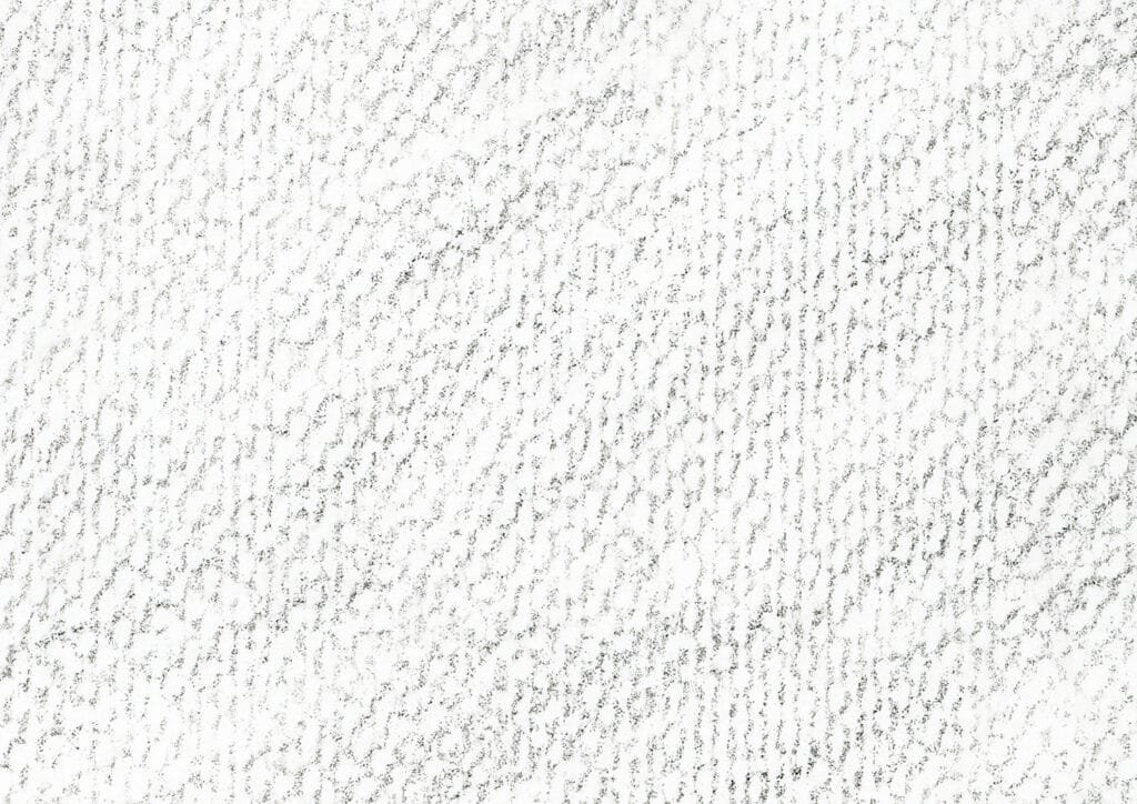 Close-up view of charcoal texture on watercolor paper.